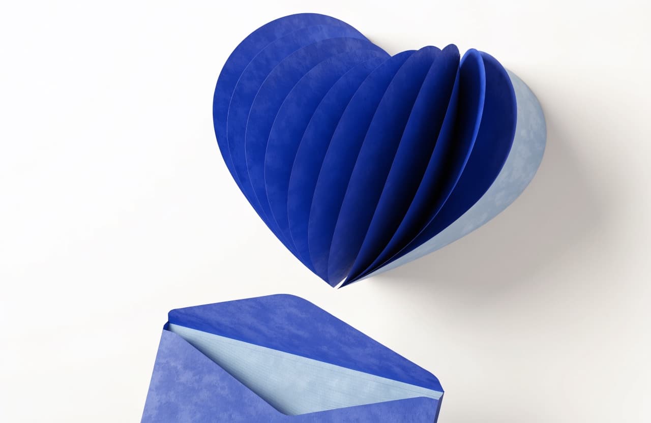 Paper-craft illustration of a letterhead page with a paper heart and an open envelope