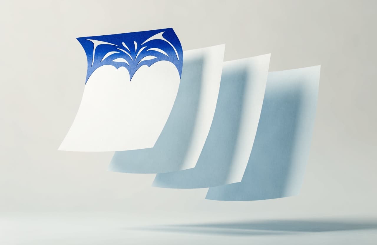 Paper-craft illustration of four letterhead pages fanned out, one raised above the rest