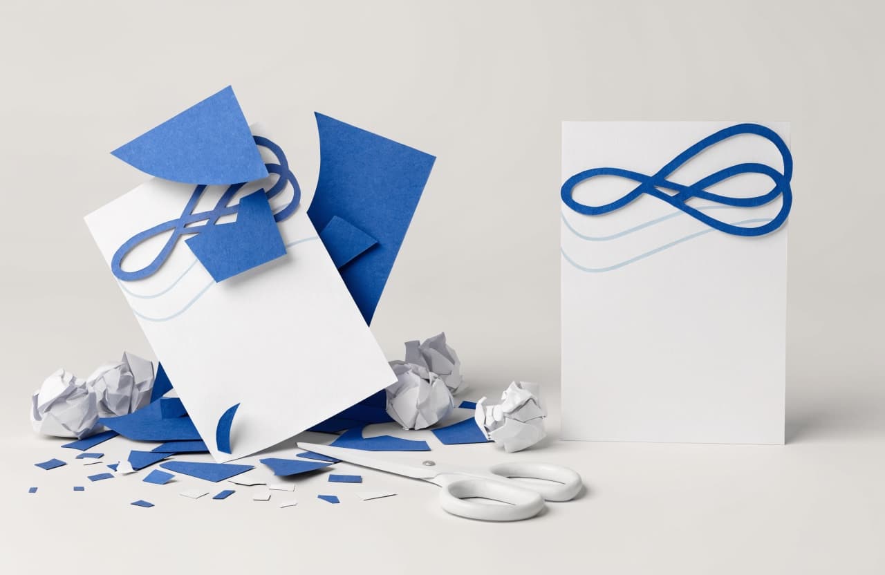 Paper-craft illustration of a messy half-assembled letterhead beside a clean finished page