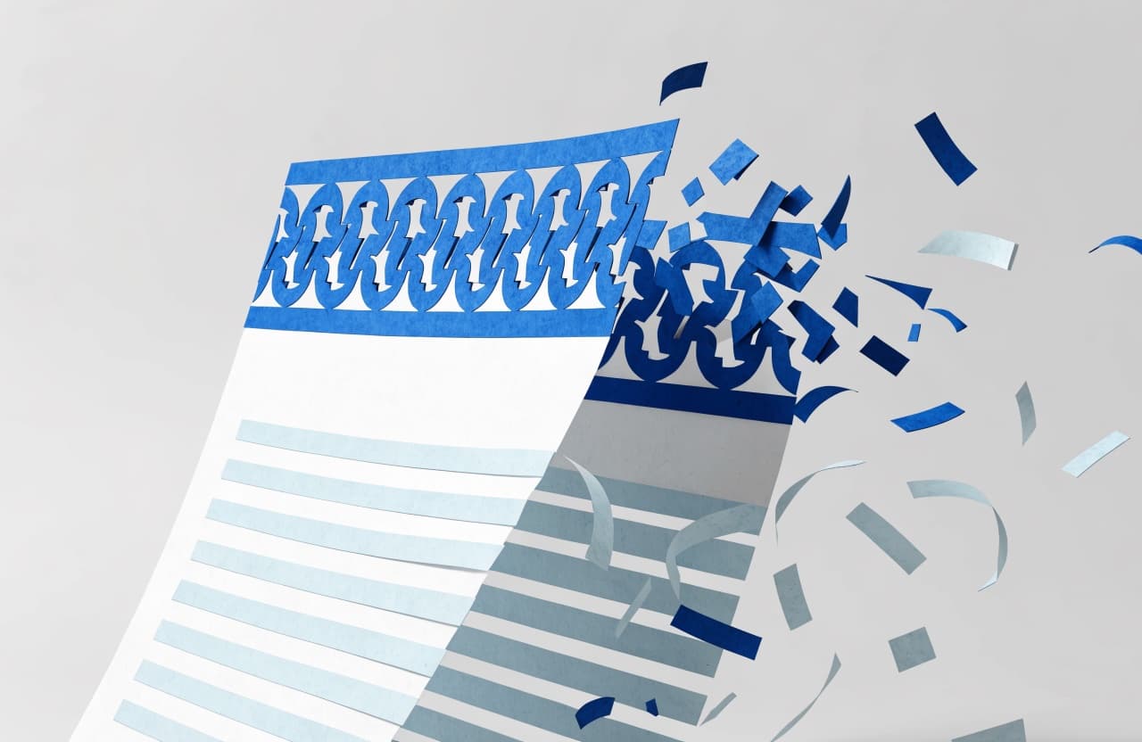 Paper-craft illustration of a letterhead page coming apart into scattered pieces