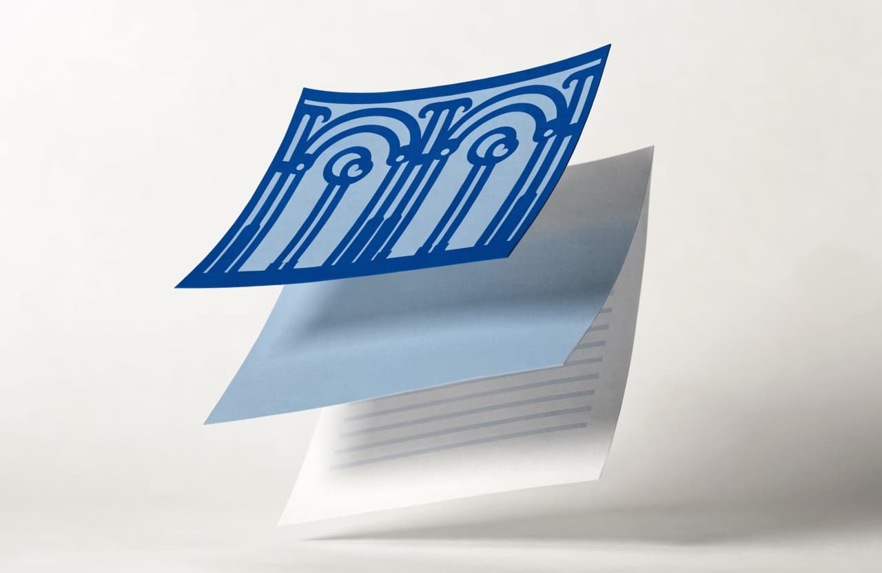 Paper-craft illustration of a decorated first page layered over a plain second page