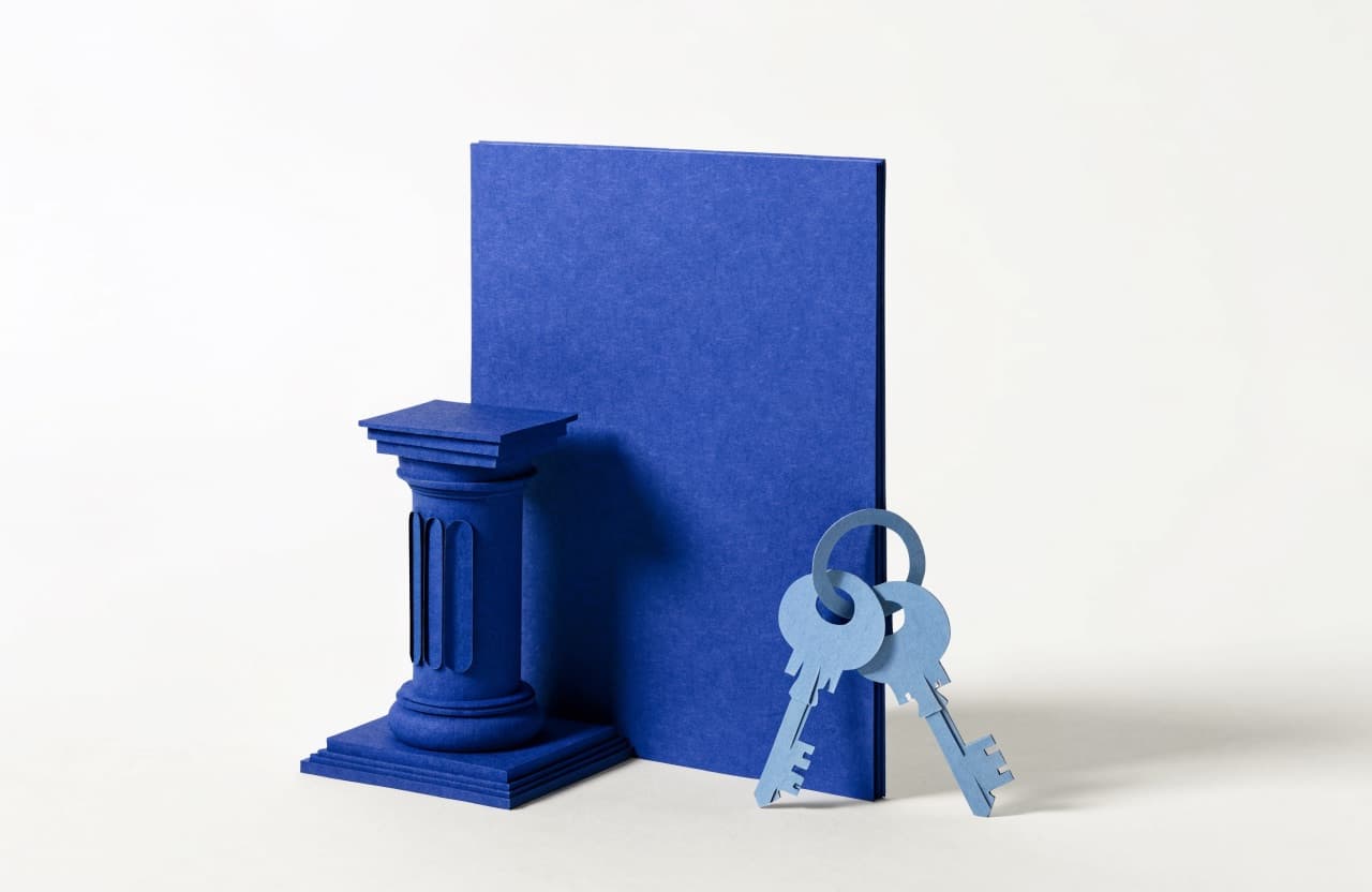 Paper-craft illustration of a letterhead page beside a paper column and a set of paper keys